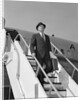 1960s Businessman Deplaning From Airplane Wearing Hat And Carrying Overcoat And Briefcase by Anonymous