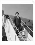 1960s Businessman Deplaning From Airplane Wearing Hat And Carrying Overcoat And Briefcase by Anonymous