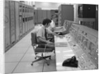 1960s 1970s Computer Room Mission Control Center Houston Texas 2 Men Sitting At Console by Anonymous