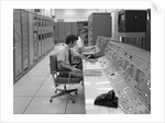 1960s 1970s Computer Room Mission Control Center Houston Texas 2 Men Sitting At Console by Anonymous
