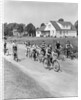 1950s 8 Kids Boys and Girls Ride Bicycles On Country Rural Road Lane Fun House In Background by Anonymous