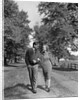 1930s 1940s Young Teen Couple Boy Girl Strolling Down Autumn Country Lane Arm In Arm by Anonymous