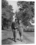 1930s 1940s Young Teen Couple Boy Girl Strolling Down Autumn Country Lane Arm In Arm by Anonymous