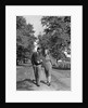 1930s 1940s Young Teen Couple Boy Girl Strolling Down Autumn Country Lane Arm In Arm by Anonymous