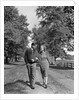 1930s 1940s Young Teen Couple Boy Girl Strolling Down Autumn Country Lane Arm In Arm by Anonymous