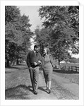 1930s 1940s Young Teen Couple Boy Girl Strolling Down Autumn Country Lane Arm In Arm by Anonymous