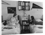 1930s 1940s Two Teen Girls Lying On Dormitory Beds Room Mates Listening To Radio College School Pennants On Wall by Anonymous