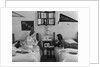 1930s 1940s Two Teen Girls Lying On Dormitory Beds Room Mates Listening To Radio College School Pennants On Wall by Anonymous