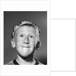 1950s Portrait Of Freckled Teen Boy Wearing Bottle Cap Beanie by Anonymous