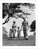 1950s Happy Family Mother Father Daughter Son Walking In Park by Anonymous