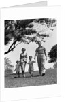 1950s Happy Family Mother Father Daughter Son Walking In Park by Anonymous