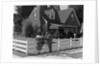 1950s Family Standing By White Fence Looking At Brick House by Anonymous