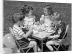 1950s Boys and Girls At Table Eating Cookies and Ice Cream For Birthday Party by Anonymous
