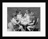 1950s Boys and Girls At Table Eating Cookies and Ice Cream For Birthday Party by Anonymous