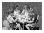 1950s Boys and Girls At Table Eating Cookies and Ice Cream For Birthday Party by Anonymous