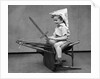1930s Boy Playing Wooden Sword Paper Hat Riding Chair Like A Horse by Anonymous
