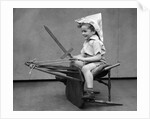 1930s Boy Playing Wooden Sword Paper Hat Riding Chair Like A Horse by Anonymous