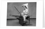 1930s Boy Playing Wooden Sword Paper Hat Riding Chair Like A Horse by Anonymous