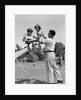 1950s Father Lifting Son And Daughter Onto A Playground Seesaw Outdoor by Anonymous