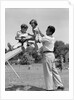 1950s Father Lifting Son And Daughter Onto A Playground Seesaw Outdoor by Anonymous