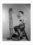 1950s Boy Eating Jelly Toast Sitting On Ladder Stacking Up Tall Pile Of Toast From Toaster by Corbis