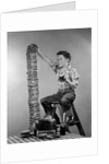 1950s Boy Eating Jelly Toast Sitting On Ladder Stacking Up Tall Pile Of Toast From Toaster by Corbis