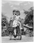 1940s Twin Girls Riding Outside On Tricycle by Anonymous