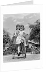 1940s Twin Girls Riding Outside On Tricycle by Anonymous