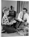 1950s Father And Son Playing With Cowboy Toy Game In Living Room Indoor by Anonymous