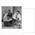 1950s Father And Son Playing With Cowboy Toy Game In Living Room Indoor by Anonymous