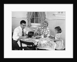 1950s Family Sitting At Kitchen Table Having Breakfast by Anonymous