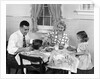 1950s Family Sitting At Kitchen Table Having Breakfast by Anonymous
