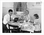 1950s Family Sitting At Kitchen Table Having Breakfast by Anonymous