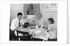 1950s Family Sitting At Kitchen Table Having Breakfast by Anonymous