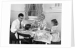 1950s Family Sitting At Kitchen Table Having Breakfast by Anonymous