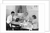 1950s Family Sitting At Kitchen Table Having Breakfast by Anonymous