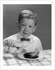 1960s Boy Wearing Bow Tie Eating Pie Dessert With Fork by Anonymous