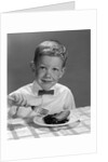 1960s Boy Wearing Bow Tie Eating Pie Dessert With Fork by Anonymous