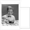 1960s Boy Wearing Bow Tie Eating Pie Dessert With Fork by Anonymous