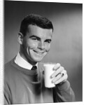 1960s Young Man Holding Glass Of Milk by Anonymous