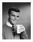1960s Young Man Holding Glass Of Milk by Anonymous