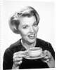 1960s Woman Drinking Coffee Holding Cup And Saucer by Anonymous