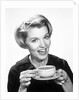 1960s Woman Drinking Coffee Holding Cup And Saucer by Anonymous