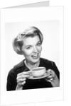 1960s Woman Drinking Coffee Holding Cup And Saucer by Anonymous