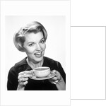 1960s Woman Drinking Coffee Holding Cup And Saucer by Anonymous