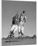 1960s Three Football Players Reaching To Catch Ball by Anonymous