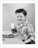 1930s 1940s Freckle-Faced Boy Sitting Dinner Table Holding Glass Milk by Anonymous