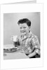 1930s 1940s Freckle-Faced Boy Sitting Dinner Table Holding Glass Milk by Anonymous