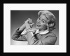 1950s 1960s Woman Making Winning Symbolic Hand Gesture With Raised Clasped Hands by Anonymous