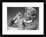 1950s 1960s Woman Making Winning Symbolic Hand Gesture With Raised Clasped Hands by Anonymous